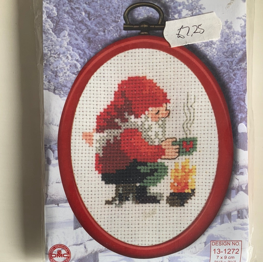 Christmas picture cross-stitches with oval frame and hanger.